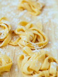 yellow pasta on brown wooden table