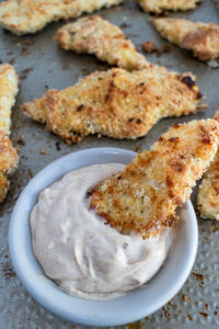 Chicken tender in a bowl of sweet mayo dip