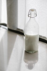 glass bottle with milk on table