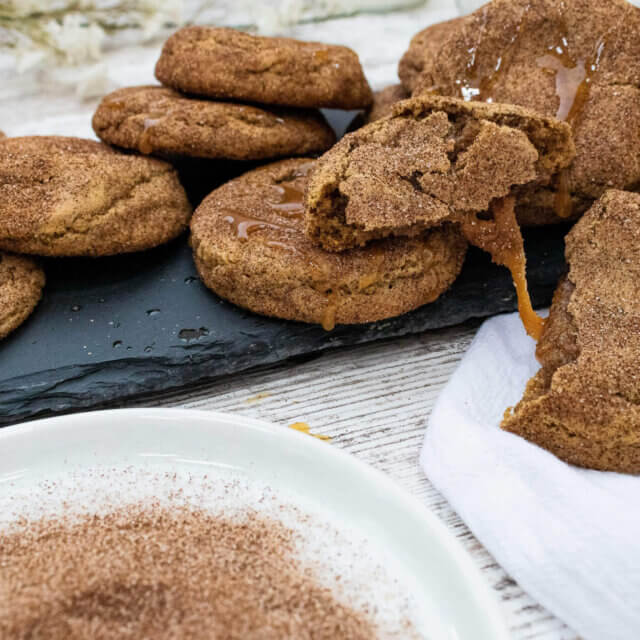 Dripping caramel stuffed snickerdoodle cookies