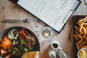 salad bowl and french fries served on table in cafe