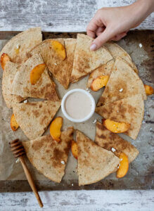 taking a peach and goat cheese quesadilla slice