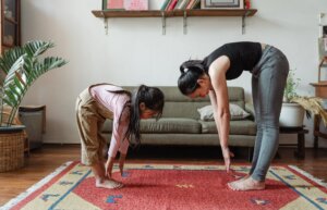 photo of woman and girl stretching their body