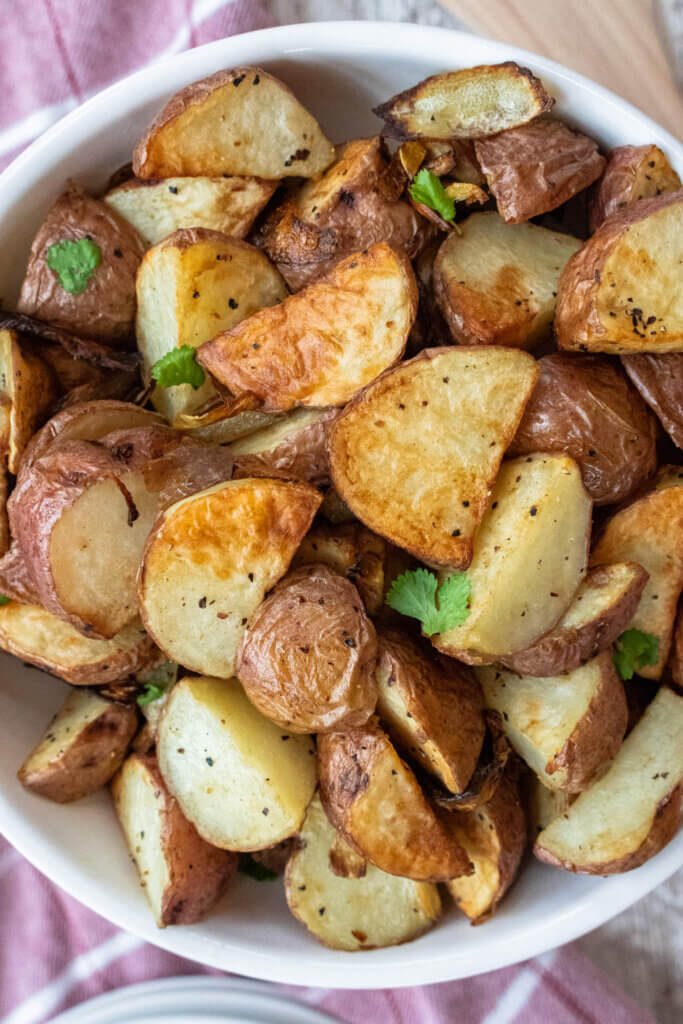 air fryer red potatoes and onions in a bowl