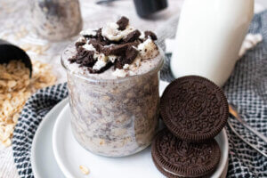 Oreo overnight oats on a white plate with cookies