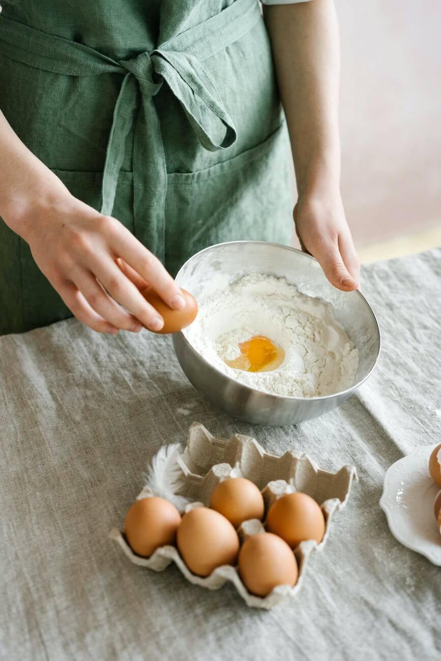 a person cracking eggs