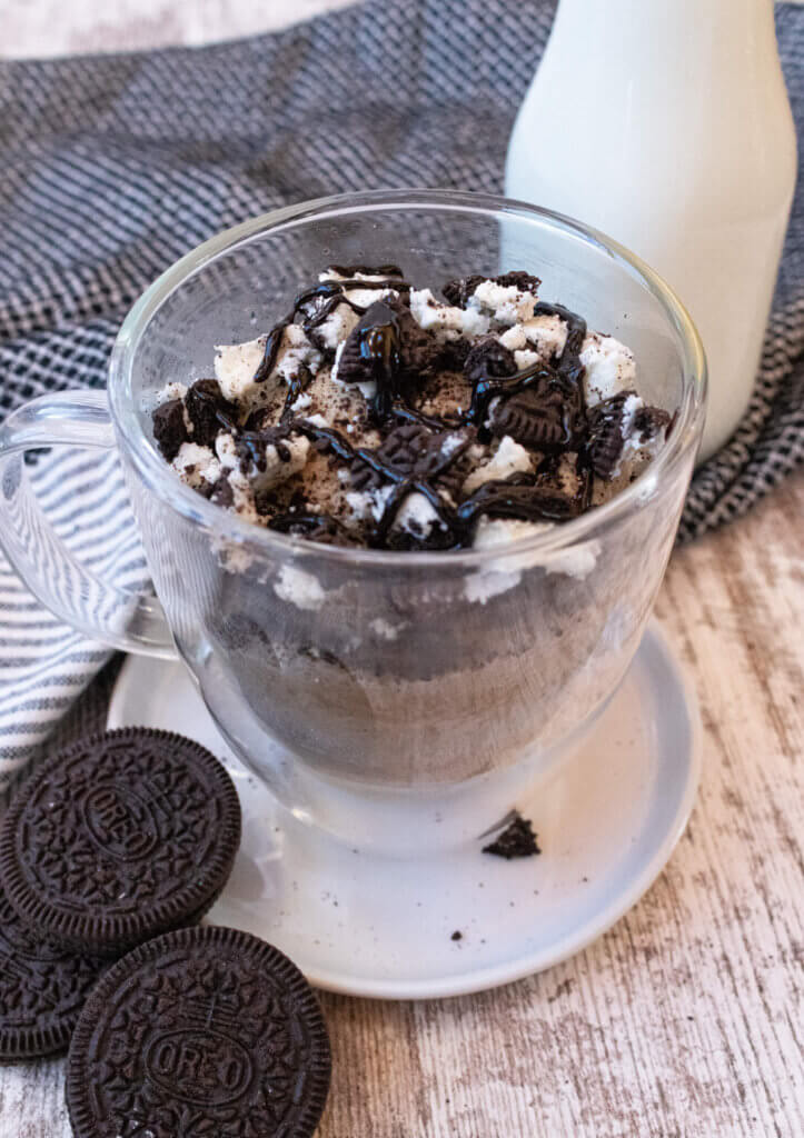 oreo mug cake topped with chocolate and oreos