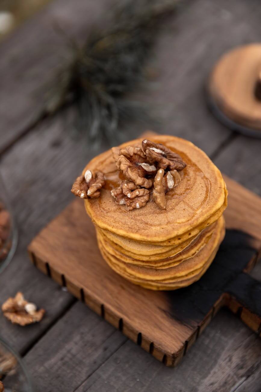 pancakes with wall nuts on wooden chopping board