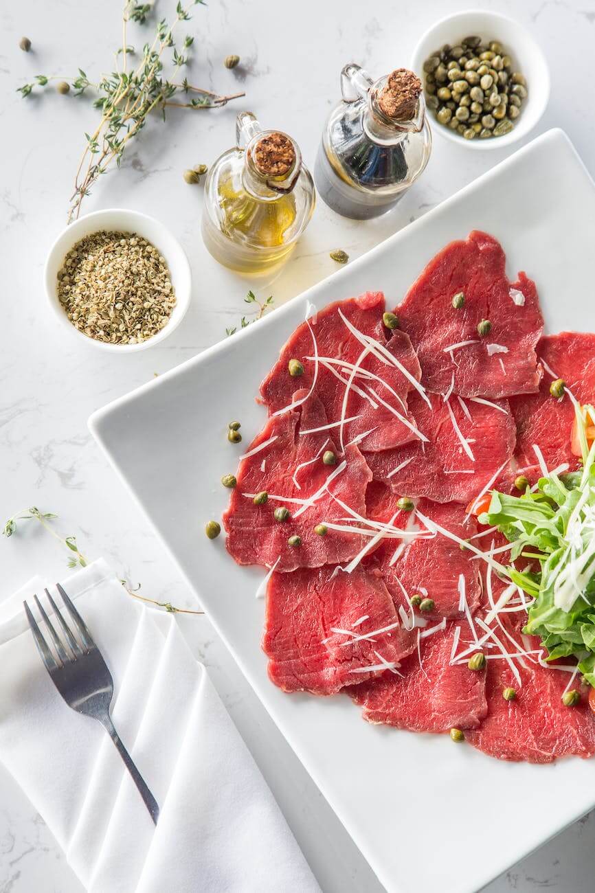 meat with vegetable and seasonings on plate