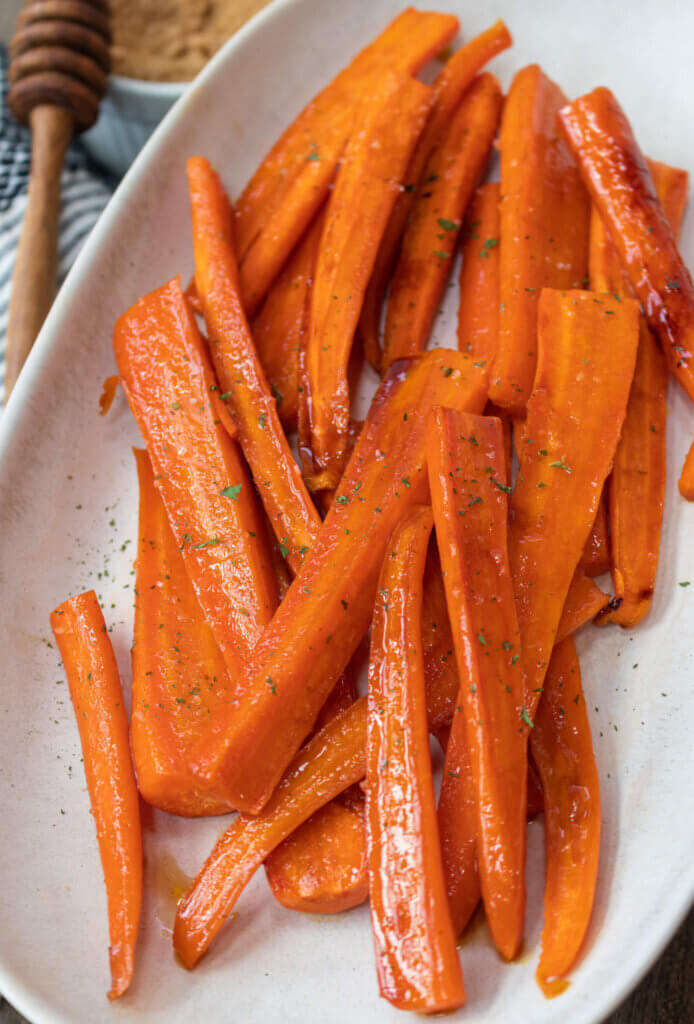 Brown sugar honey glazed carrots in white bowl