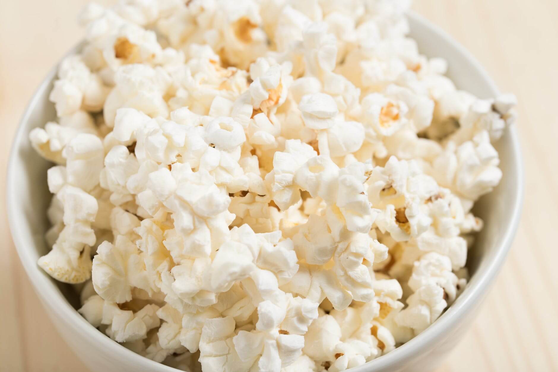 macro friendly snack of white popcorns on round white ceramic bowl