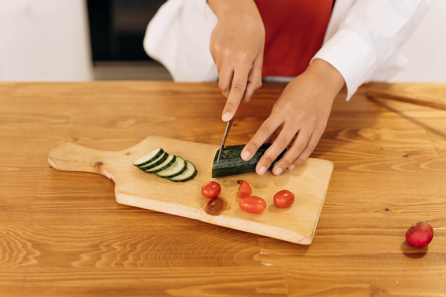 woman slicing a cucumber