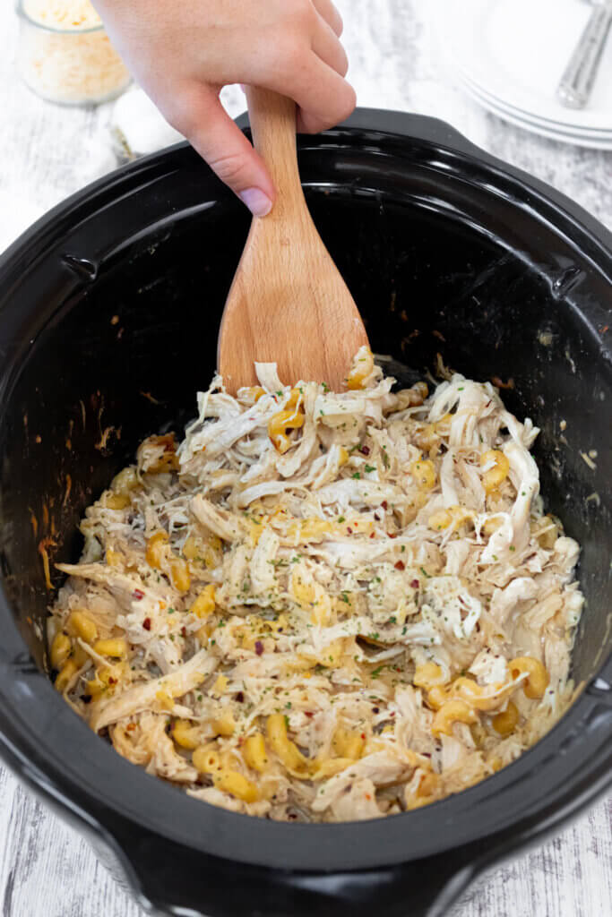 Crockpot Garlic Parmesan Chicken Pasta with wooden spoon