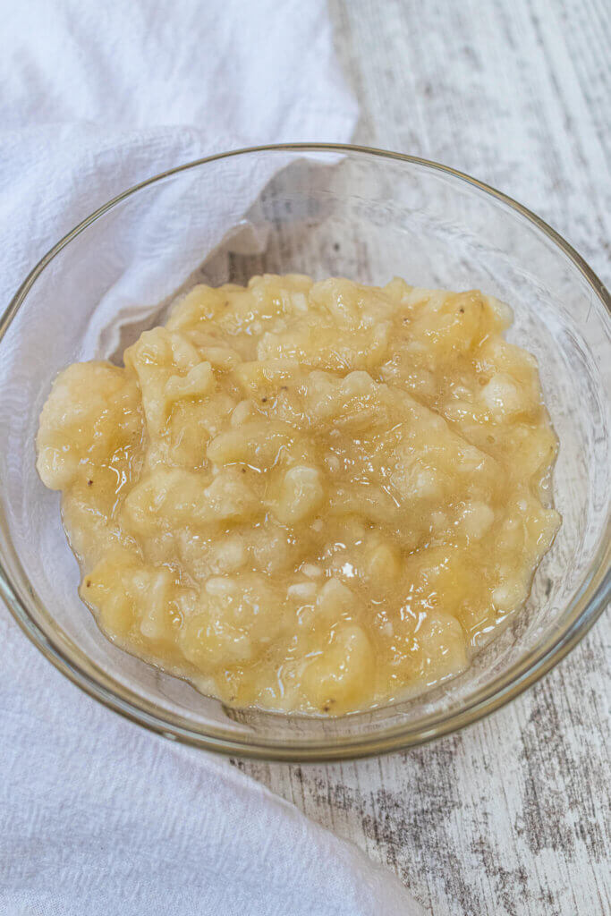 mashed banana in glass bowl for banana bread without baking soda