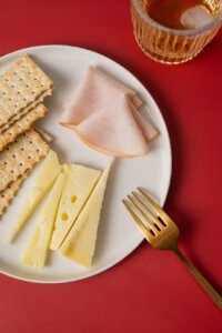 ham and cheese with crackers on the plate