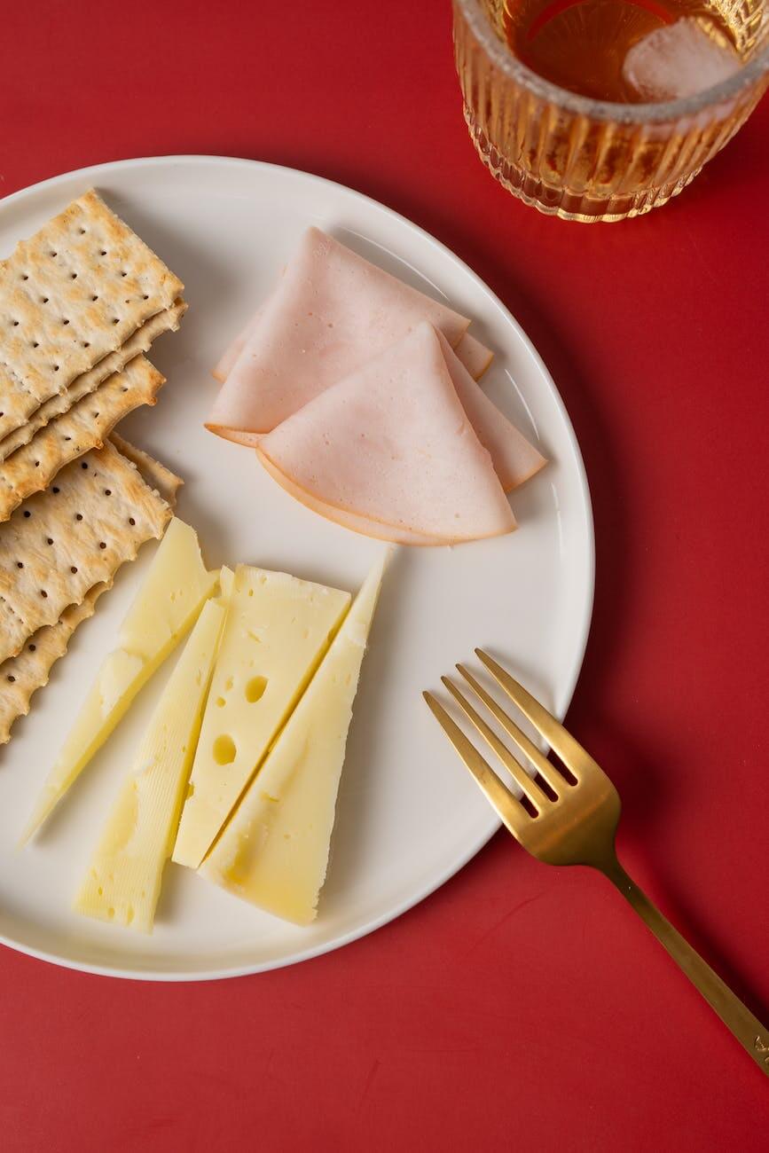 ham and cheese with crackers on the plate as balanced snacks