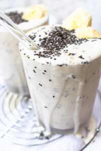 Creamy banana chia smoothie dripping out of cup