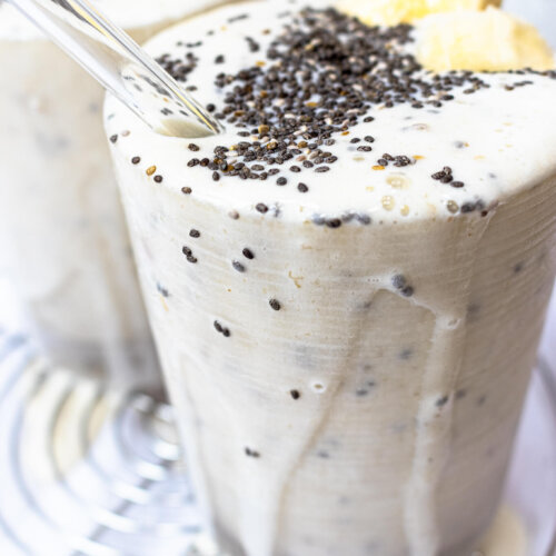 Creamy banana chia smoothie dripping out of cup