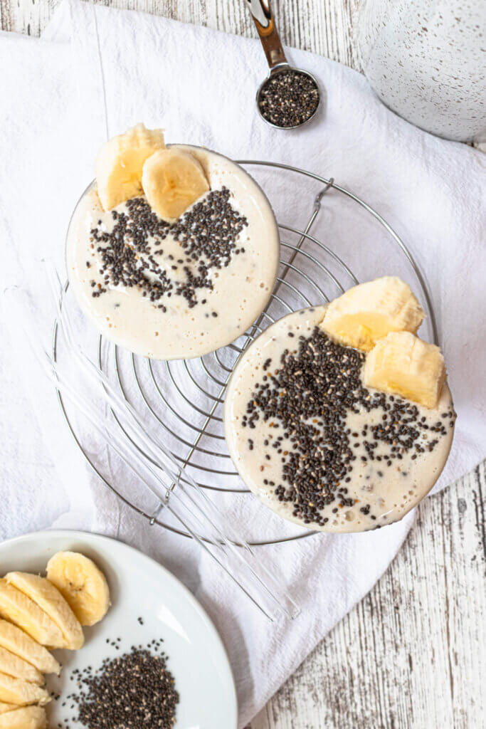 two banana chia smoothies on metal circle