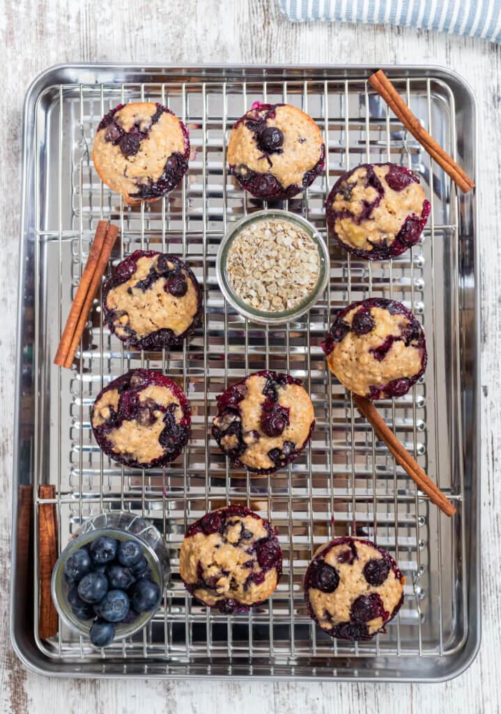 Muffins on cooling rack with cinnamon and oats