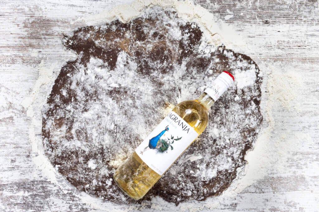 Wine bottle on cinnamon roll dough