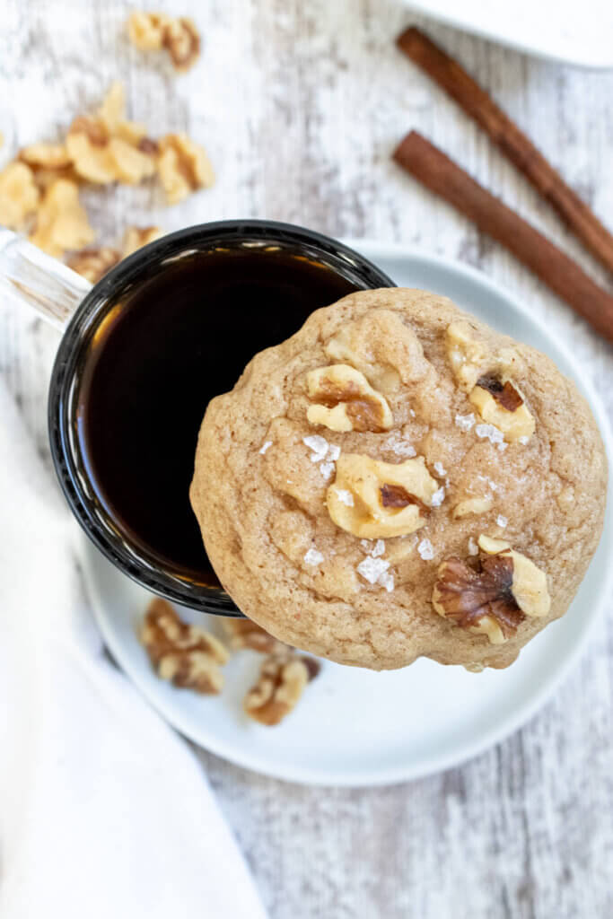 salted maple walnut cookie sitting on coffee cup