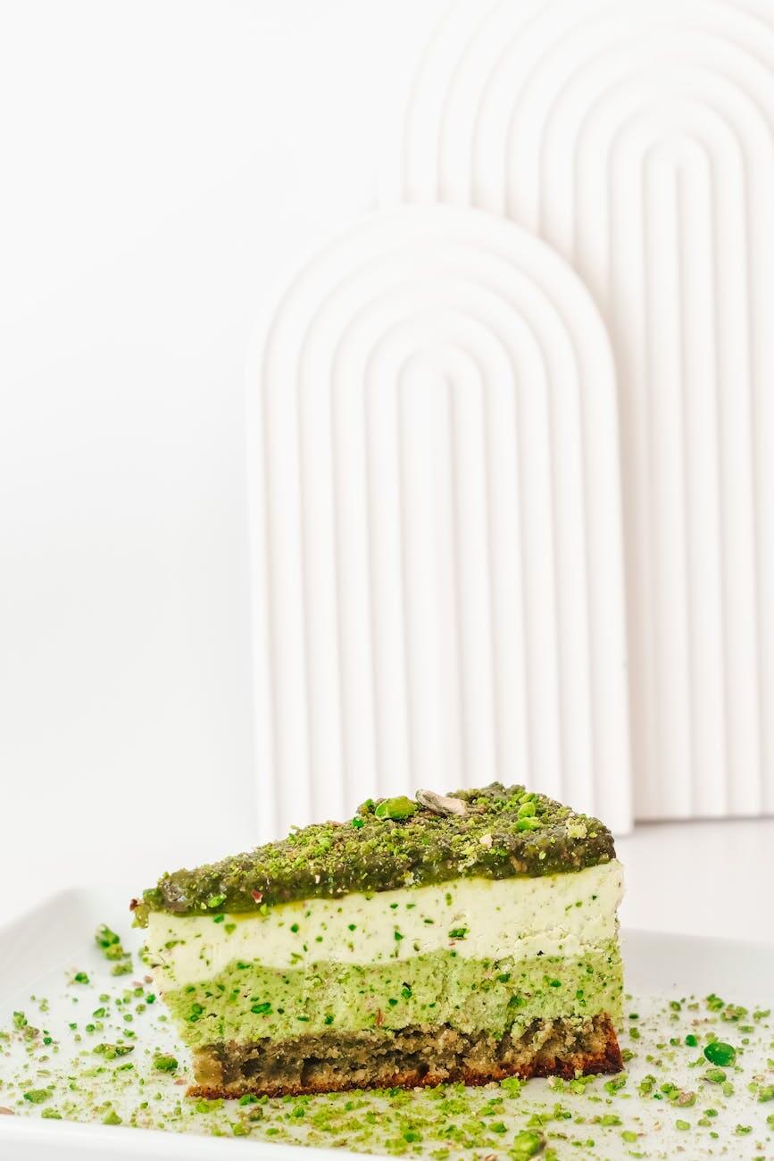 green pistachio butter cake with cream on white background