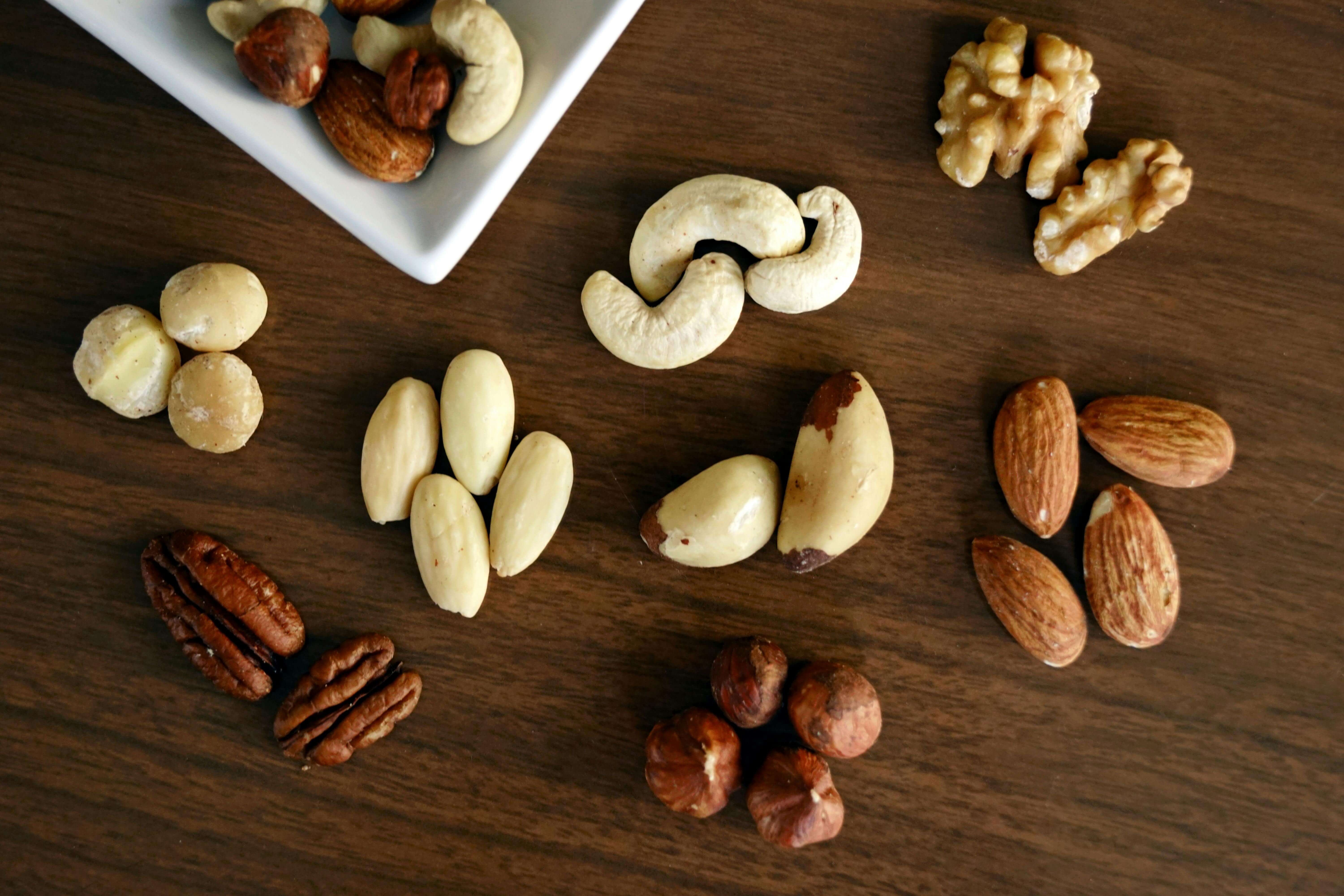 walnuts vs pecans on brown table