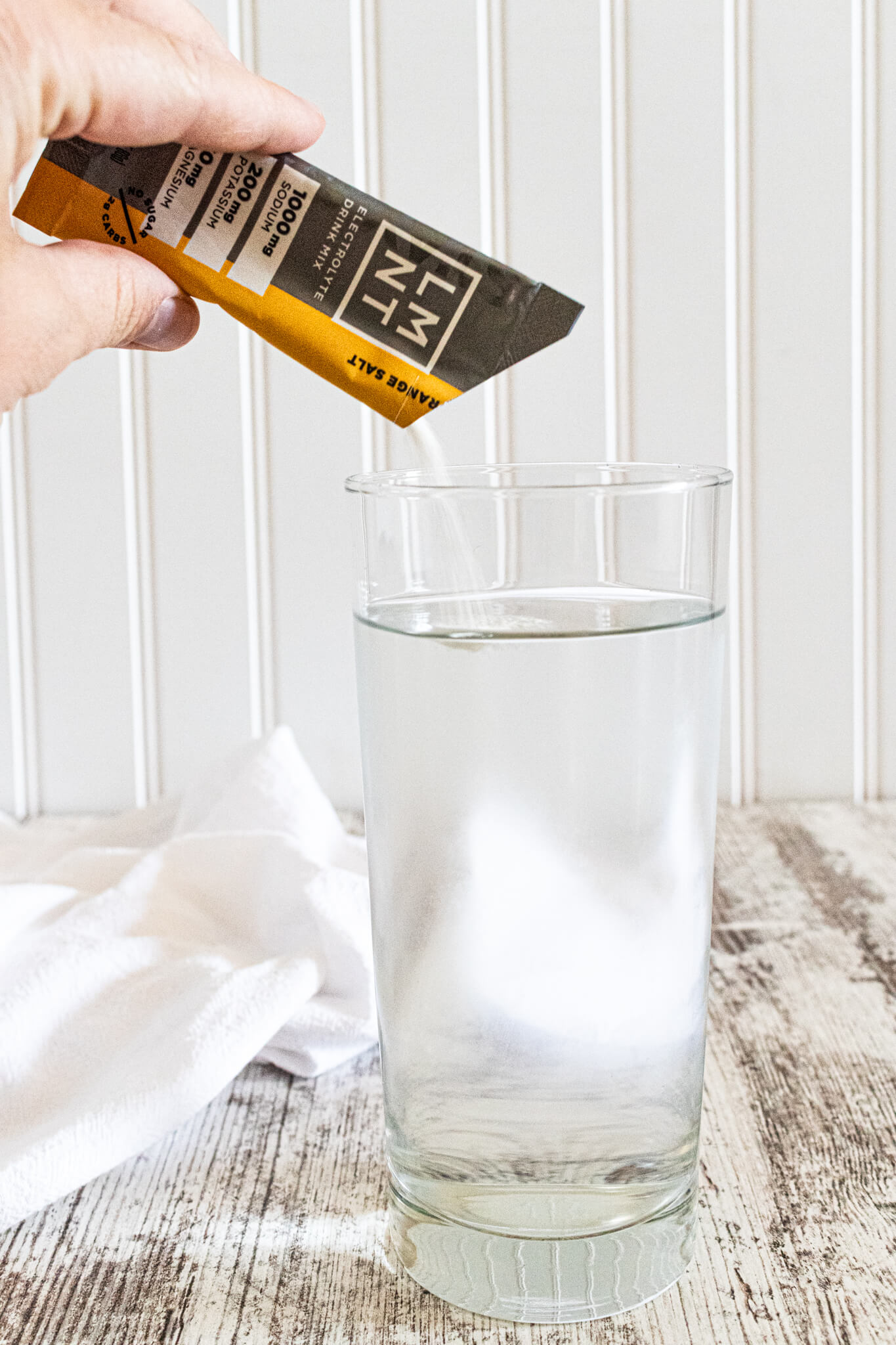 Pouring LMNT into a glass of water