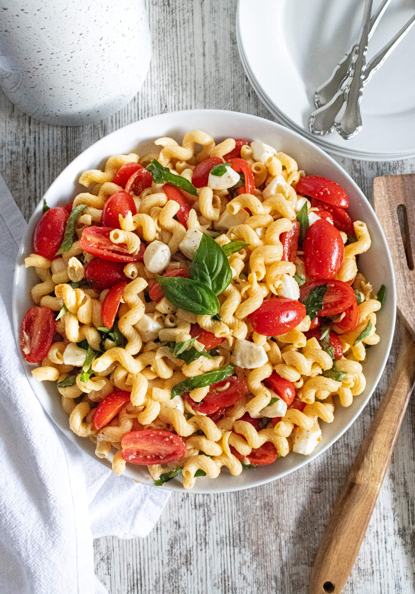 easy caprese pasta salad in white bowl