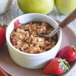 strawberry apple crisp in white bowl