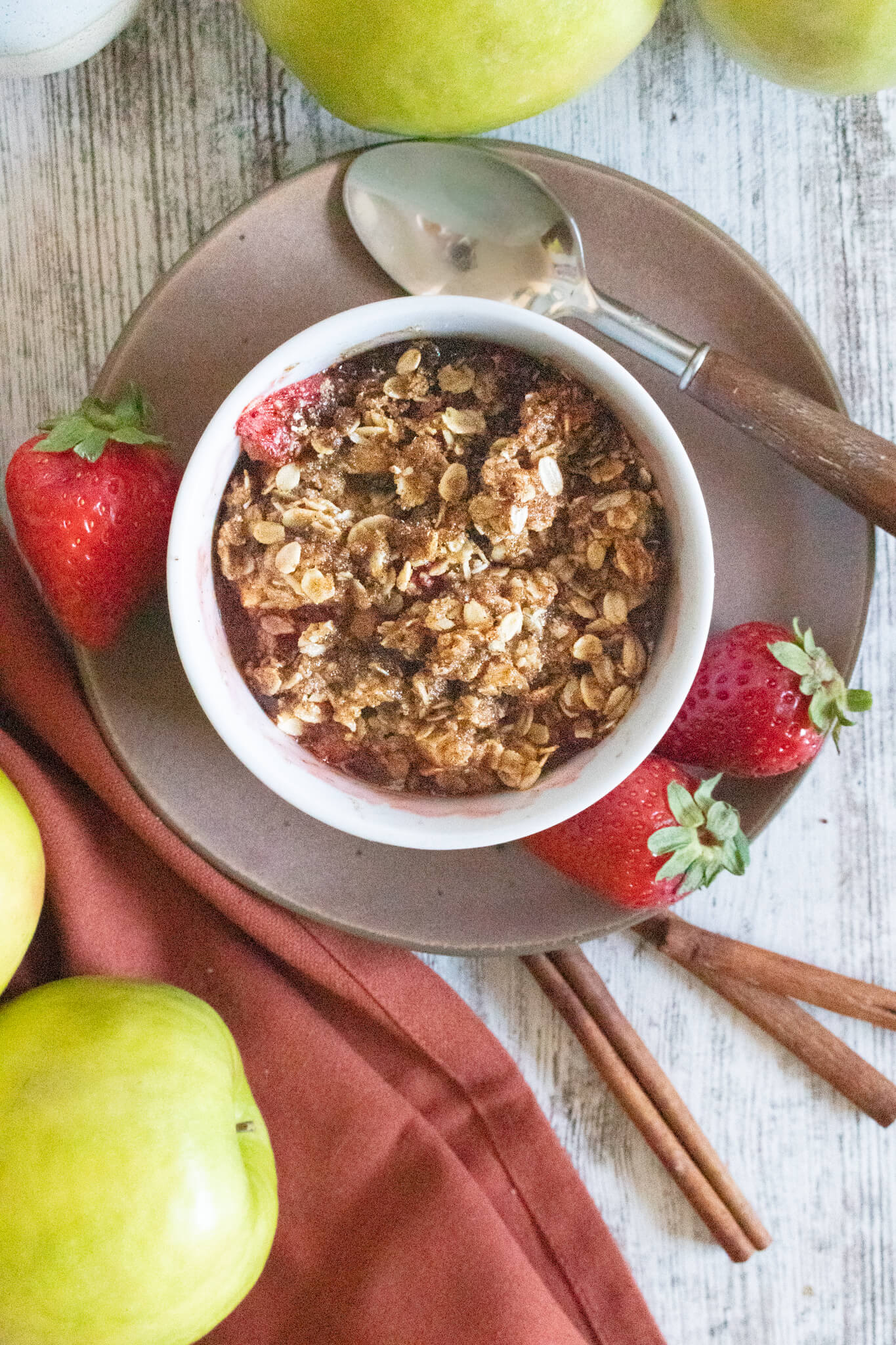 Strawberry Apple Crisp for one on a brown plate