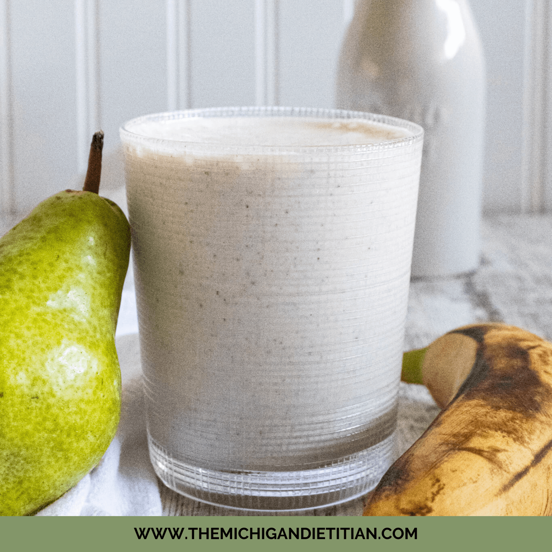 Pear and banana smoothie in glass cup